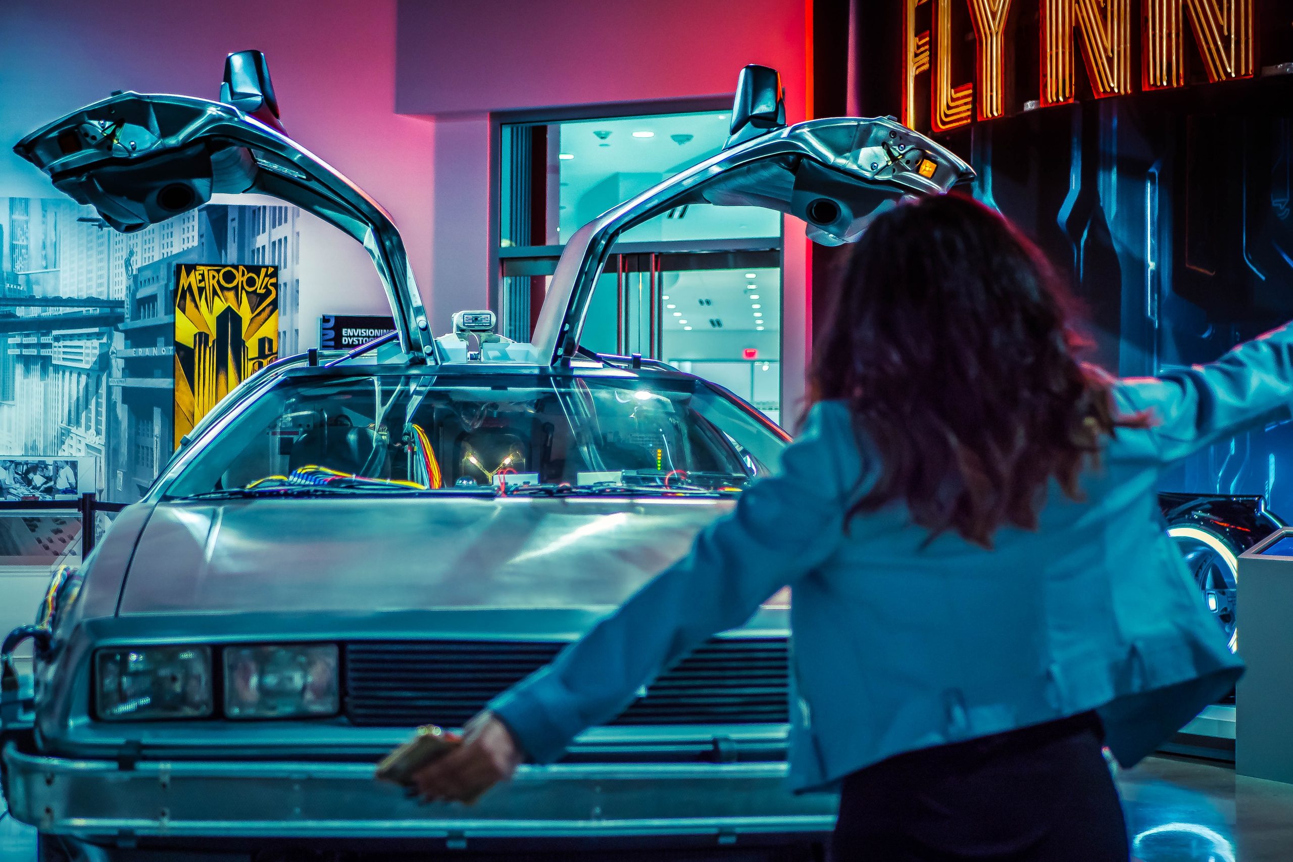 woman in front of a delorean